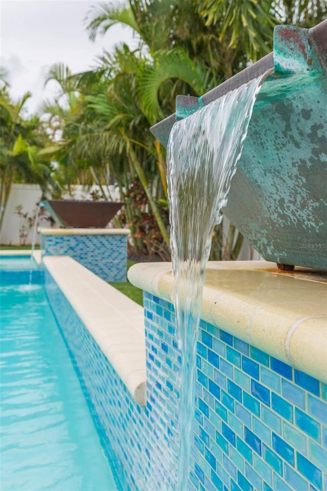 view of pool with pool water feature