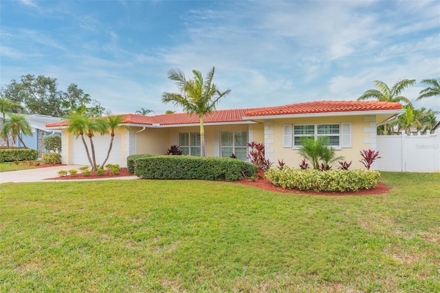 ranch-style home with a garage and a front yard