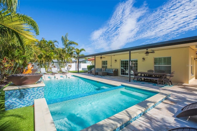 view of swimming pool with a patio area, an outdoor living space with a fire pit, and ceiling fan