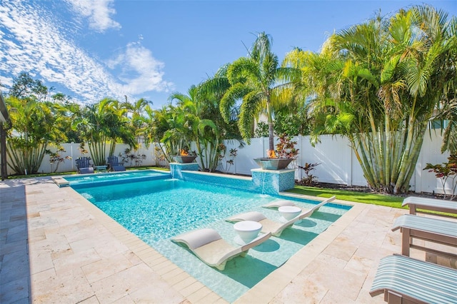 view of swimming pool featuring pool water feature and a patio area