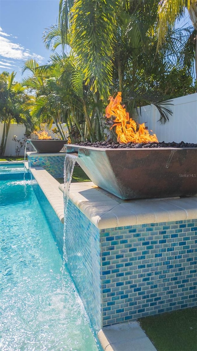 view of pool with pool water feature