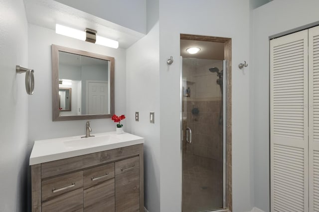 bathroom featuring vanity and a shower with shower door