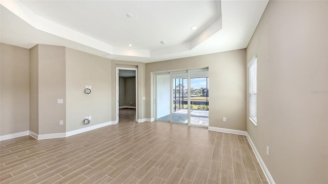 unfurnished room with a raised ceiling