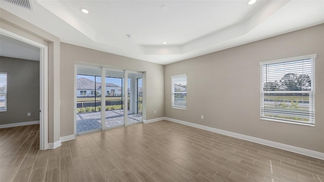 spare room featuring a tray ceiling