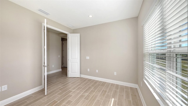 spare room with light wood-type flooring