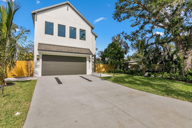 modern home featuring a front yard and a garage