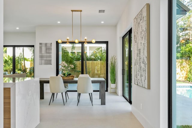 dining space with an inviting chandelier