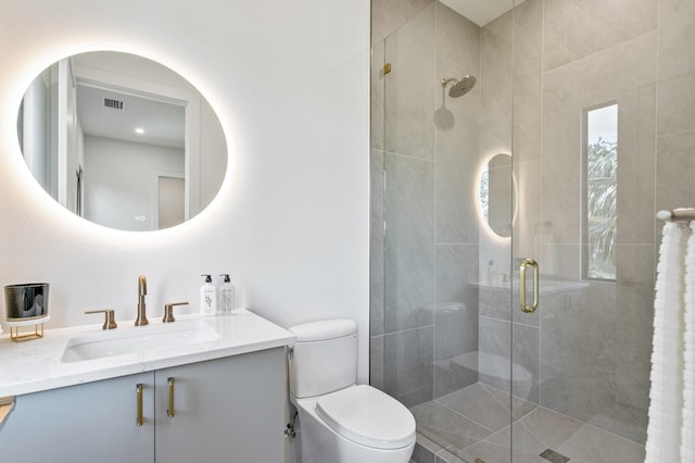 bathroom featuring an enclosed shower, vanity, and toilet