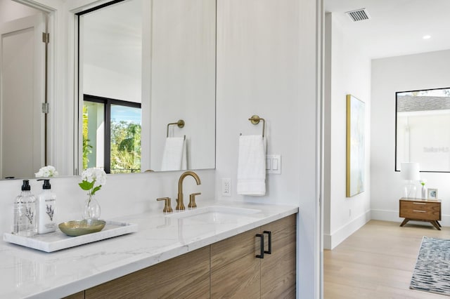 bathroom with vanity and hardwood / wood-style flooring