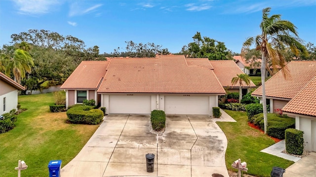 view of front of house with a garage and a front yard