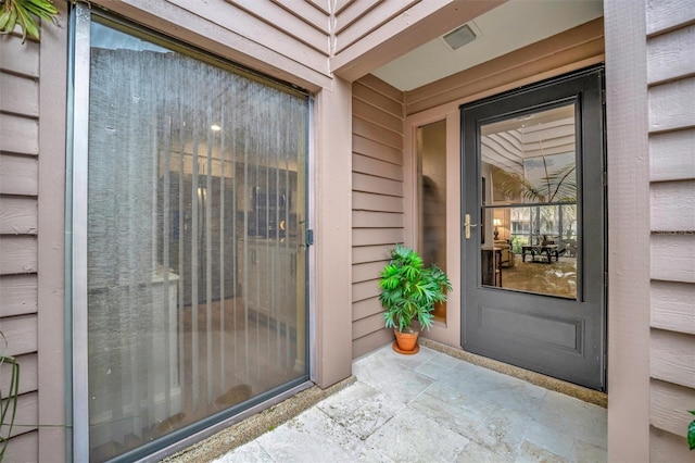 property entrance featuring a patio area