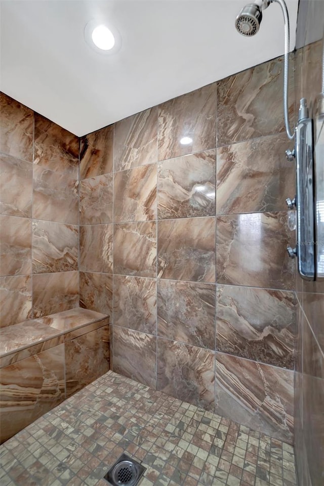 bathroom with tiled shower