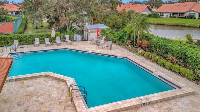 view of swimming pool featuring a patio area and a water view