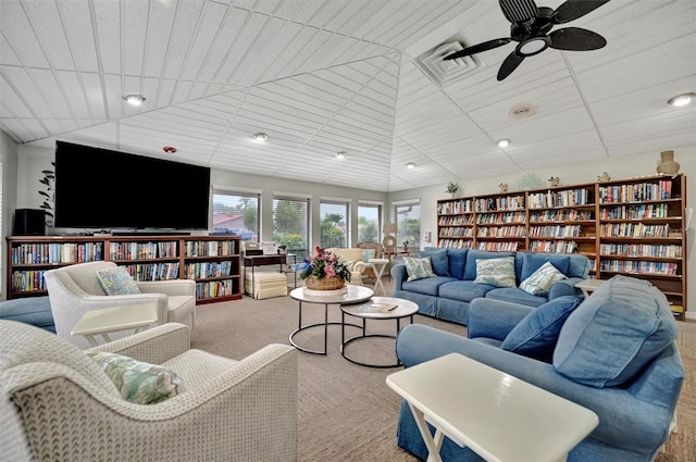 living room with ceiling fan, light carpet, and vaulted ceiling