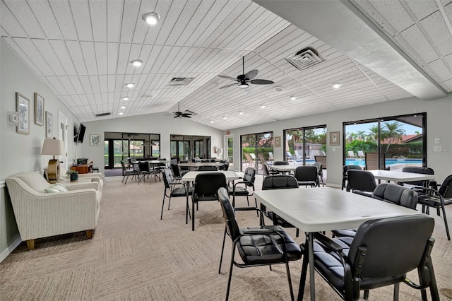 carpeted dining room featuring ceiling fan, plenty of natural light, and vaulted ceiling