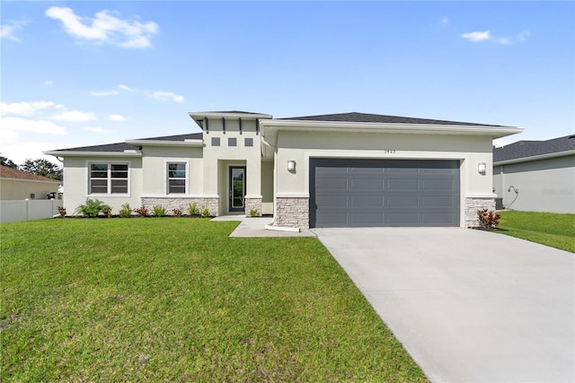 prairie-style home with a garage and a front lawn