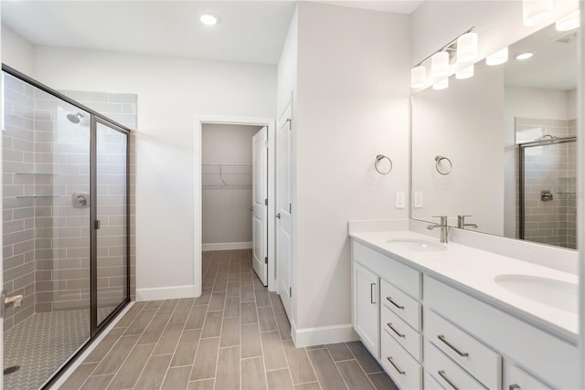 bathroom featuring vanity and an enclosed shower