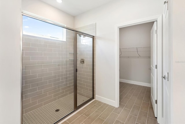 bathroom with a shower with door