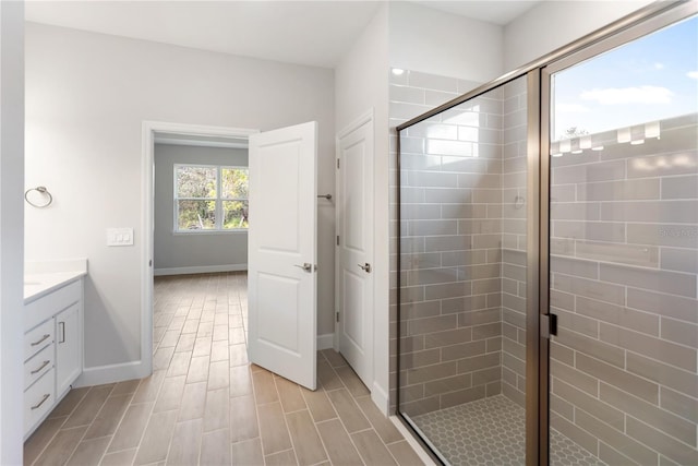 bathroom featuring vanity and an enclosed shower