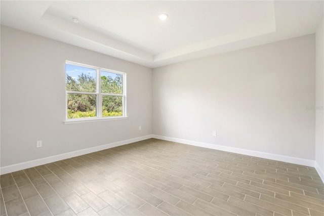 empty room featuring a raised ceiling