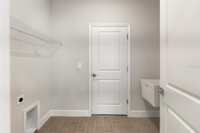 washroom with hookup for an electric dryer