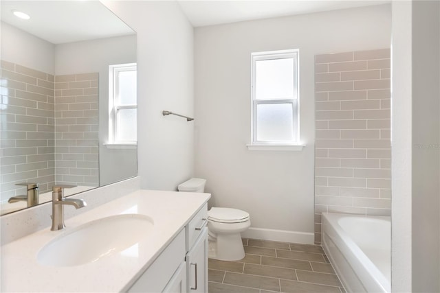 full bathroom featuring vanity, toilet, and tiled shower / bath combo