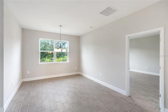 unfurnished room with a chandelier