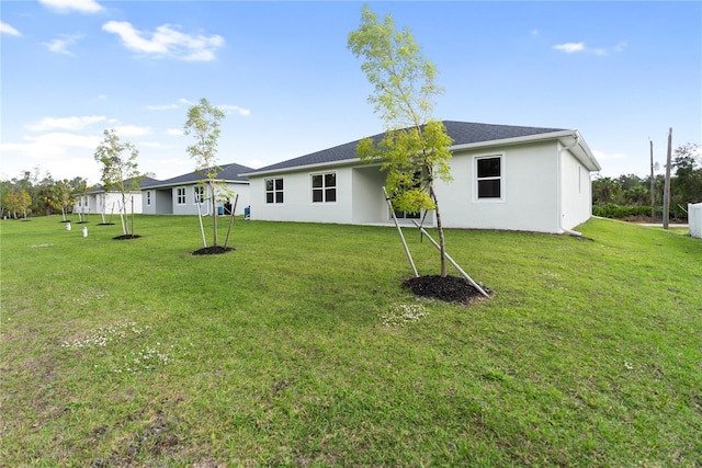 back of house featuring a yard