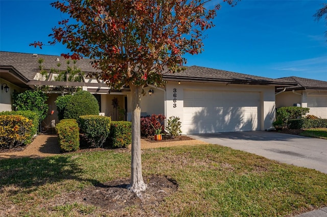 view of front of home featuring a garage and a front lawn