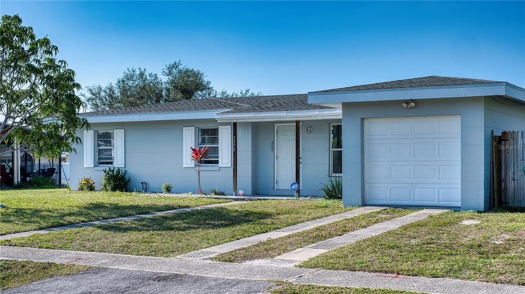 ranch-style house with a garage and a front yard