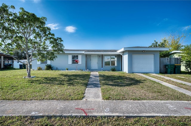 ranch-style home with a garage and a front lawn