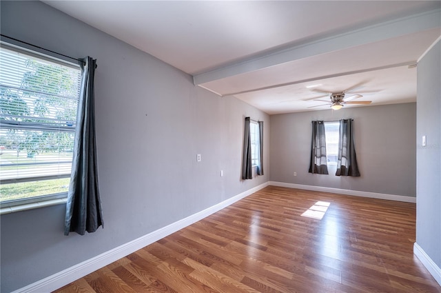 empty room with hardwood / wood-style flooring, plenty of natural light, and ceiling fan