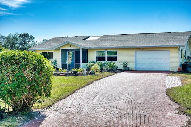 ranch-style house with a garage and a front yard