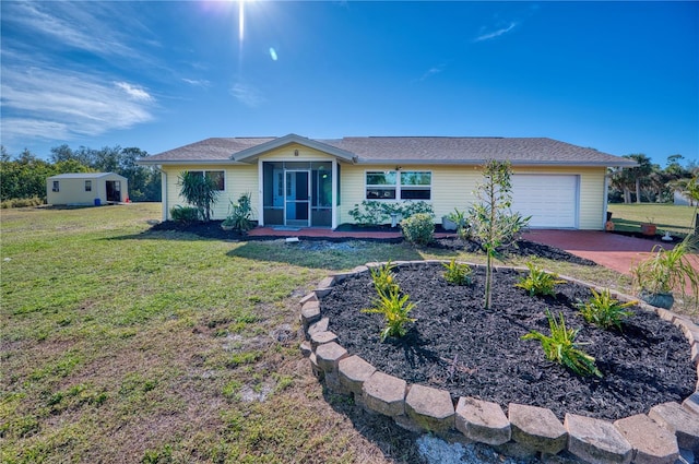 ranch-style home featuring a garage and a front lawn