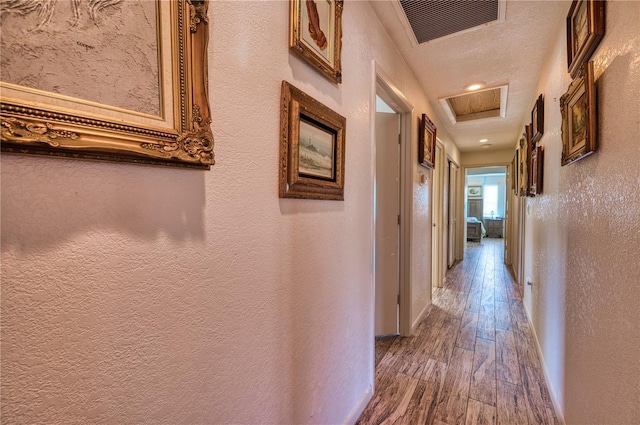 corridor with hardwood / wood-style flooring