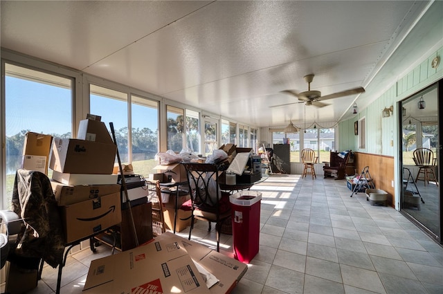 sunroom featuring ceiling fan