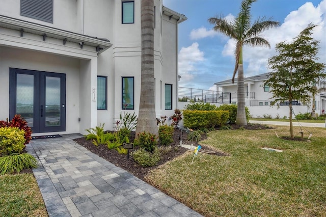 doorway to property featuring a yard