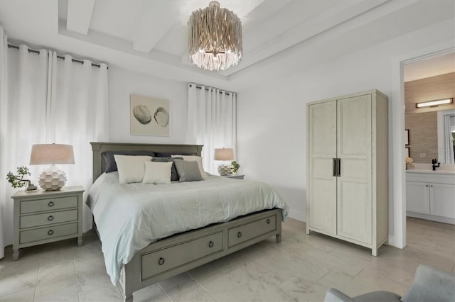 bedroom with ensuite bathroom and an inviting chandelier