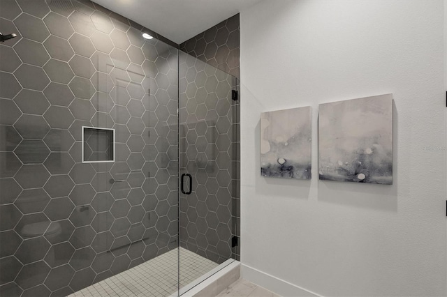 bathroom with a shower with shower door