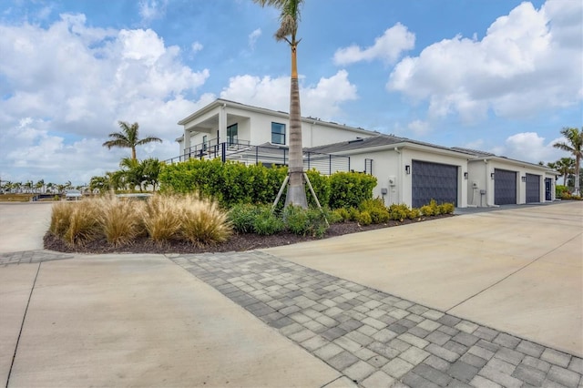 view of front of property featuring a garage and a balcony