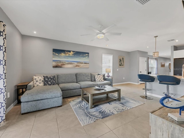 living room with light tile patterned floors, ceiling fan, and a wealth of natural light