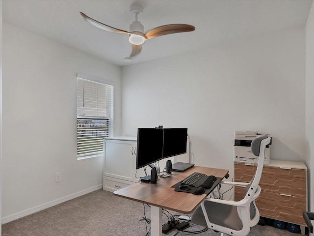 carpeted office space with ceiling fan