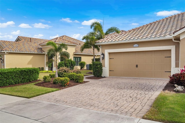 mediterranean / spanish home with a garage