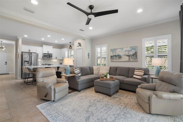 tiled living room featuring ceiling fan and crown molding