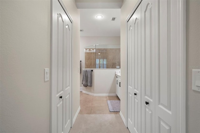 hall with light tile patterned floors