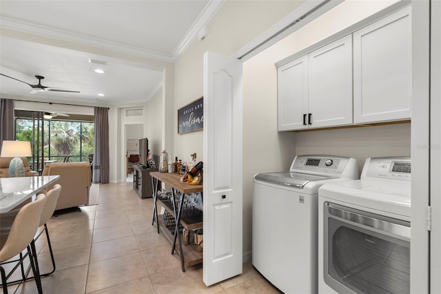 laundry room featuring cabinets, independent washer and dryer, ceiling fan, light tile patterned floors, and crown molding