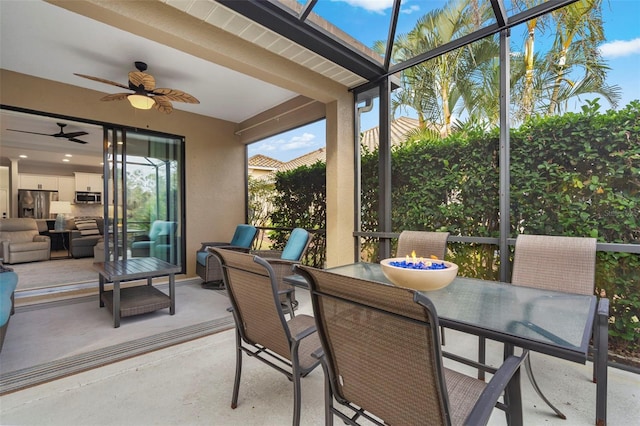 sunroom / solarium featuring ceiling fan