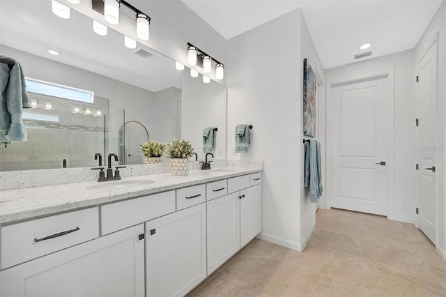 bathroom featuring vanity and a shower with door