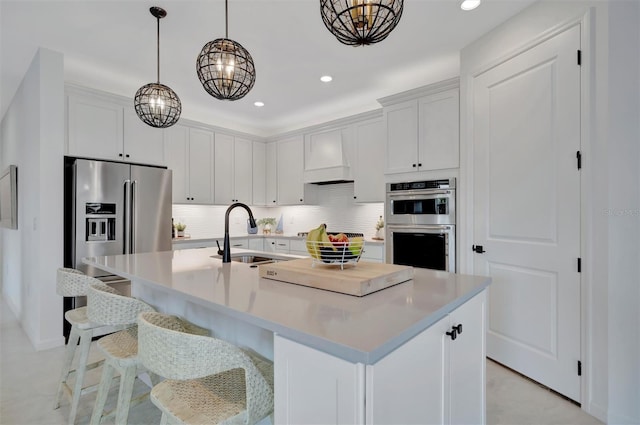 kitchen featuring sink, white cabinets, and a kitchen island with sink