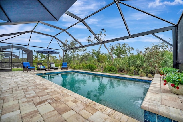 view of swimming pool featuring outdoor lounge area, a patio, and glass enclosure